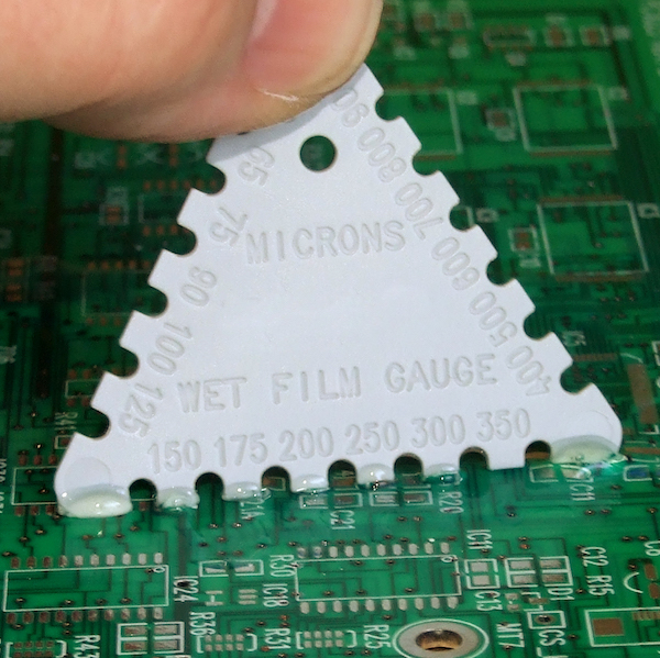 A wet film gauge is a low cost method for measuring coating thickness while the conformal coating is wet. Using the solids content in the material and the wet film thickness allows the dry film thickness to be estimated.
