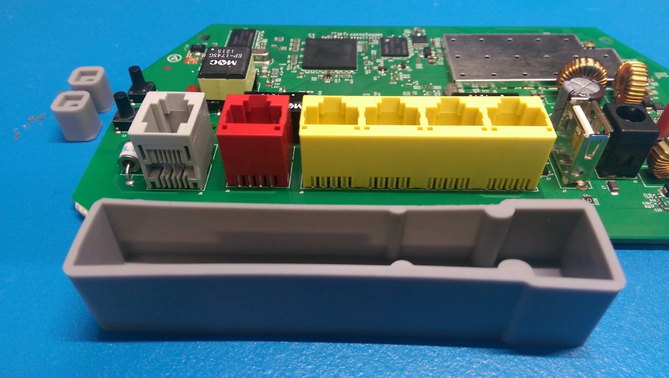 Reusable silicone masking boot for conformal coating, showing the connector being masked