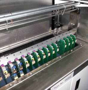 PCBs being dipped in conformal coating using a DS101 dip coating system for full coverage and controlled film thickness