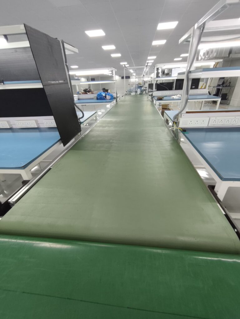 Before and after comparison of PVC conveyor belt restored using flexible ProShieldESD conductive coating in electronics assembly line